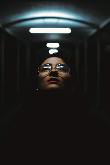 Atmospheric portrait of a girl in a dark tunnel