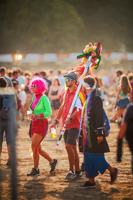 Photo of colorfully dressed festival goers with good bokeh background